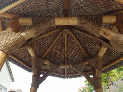 Palapa roof from below: bamboo rafters and rope-wrapped beams