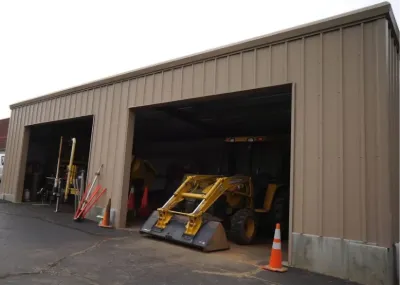 Steel building with large openings for equipment storage