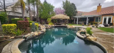 Lagoon-style pool with a palapa beyond