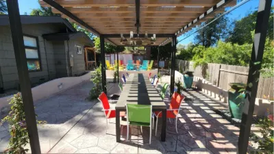 Long dining table under a patio cover