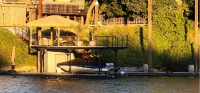 Thatched palapa on a lakeside dock at golden hour