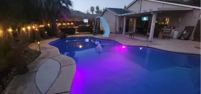 Pool and string-lit patio at dusk