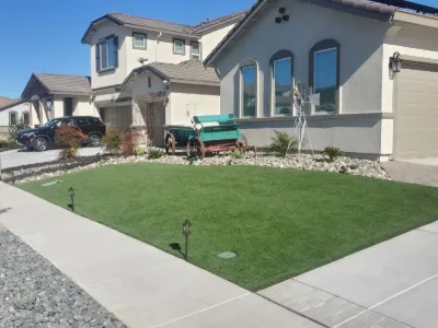 Front-yard synthetic lawn with path lighting