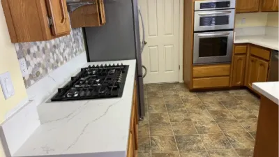 Kitchen with new quartz counters and a gas cooktop