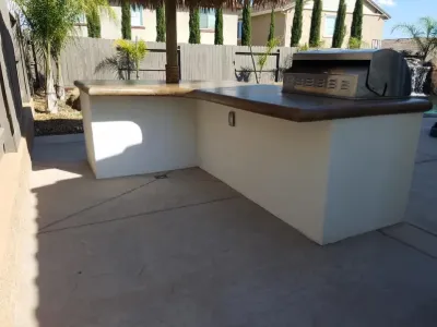 L-shaped outdoor kitchen counter with built-in grill